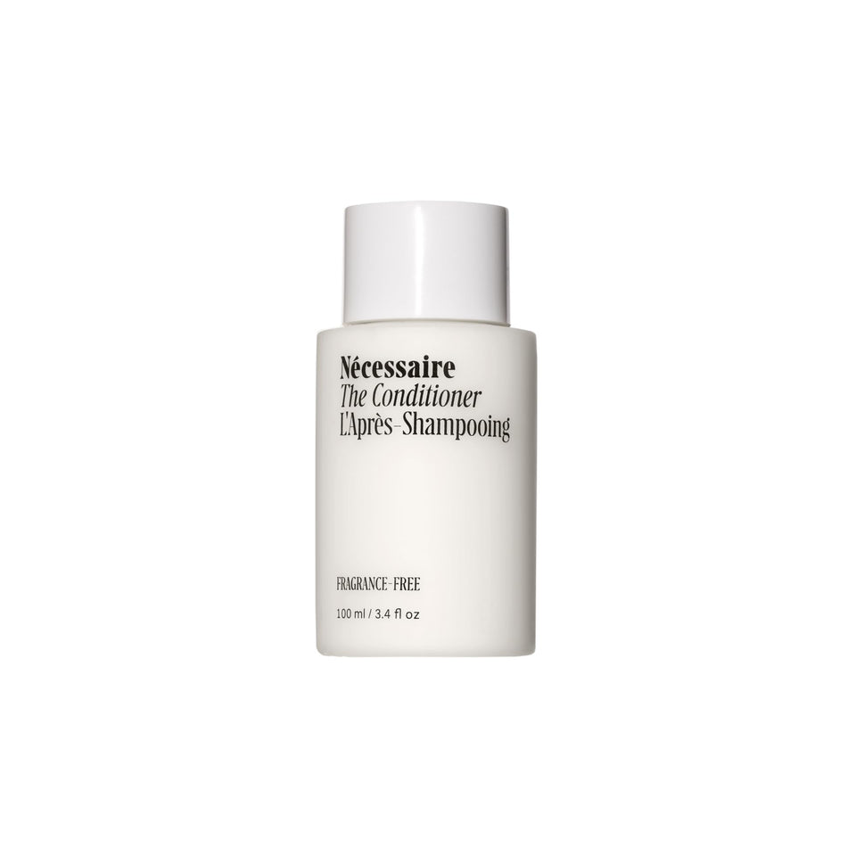 Nécessaire mini conditioner front bottle showing compact travel size and clarity