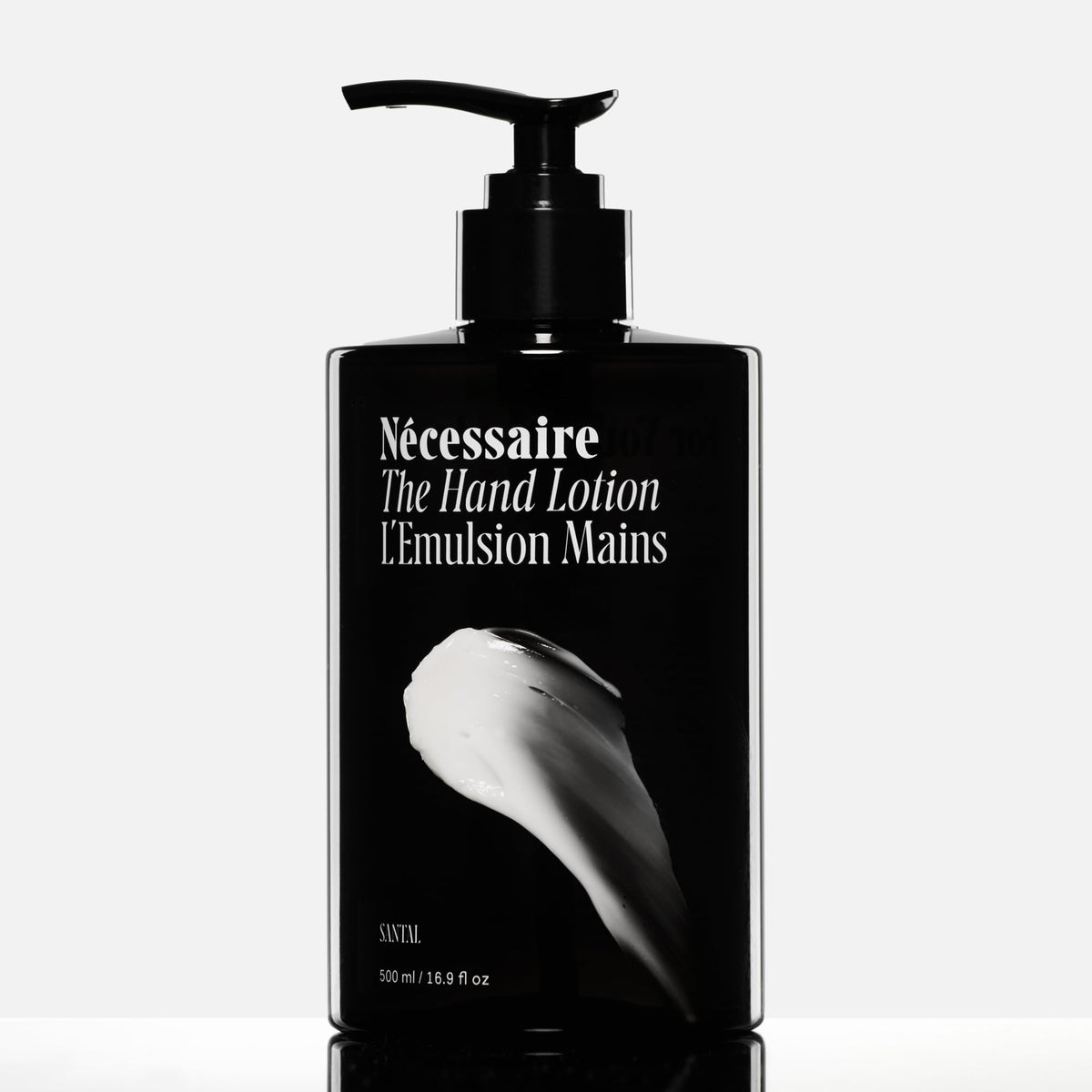 Nécessaire lotion texture on hand showing creamy spreadability and quick absorption benefit