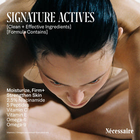 Nécessaire bottle held in hand to show 450ml scale and travel-friendly pump