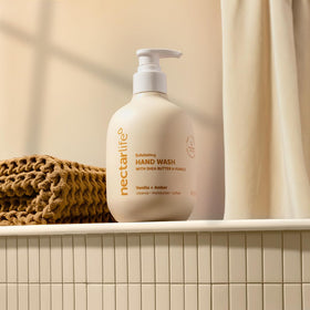 Nectar Life bottle on sink with vanilla props showing fragrant relaxing benefit