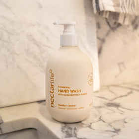 Nectar Life bottle beside hands for size comparison and ease-of-use benefit