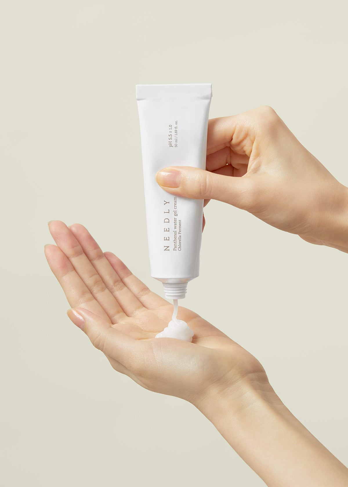 NEEDLY jar in hand to show compact size and travel-friendly convenience