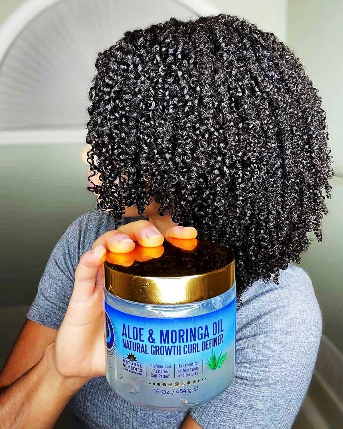 Nefertiti's Secrets on model showing natural shiny defined curls