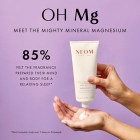 Applying Neom body butter on hands to moisturize skin and soothe before bed