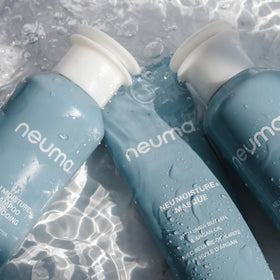 NEUMA bottle styled on bathroom shelf conveying clean-beauty lifestyle appeal