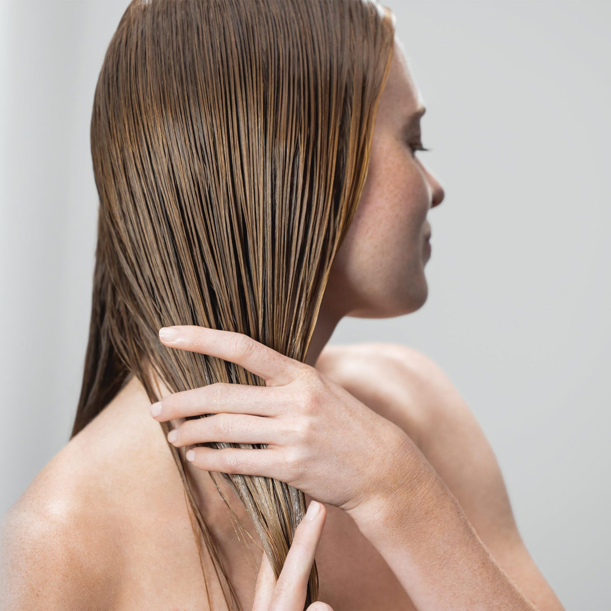 Neuro Prime being applied to damp hair demonstrating prep step that improves blow-dry results