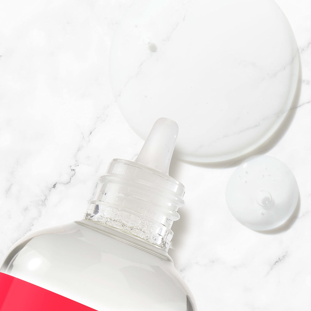 Neutrogena bottle in hand dispensing drop, easy application benefit