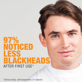 Neutrogena scrub placed on bathroom shelf conveying daily routine benefits