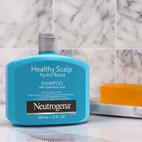 Neutrogena bottle in hand showing 12 fl oz size for scale and convenience