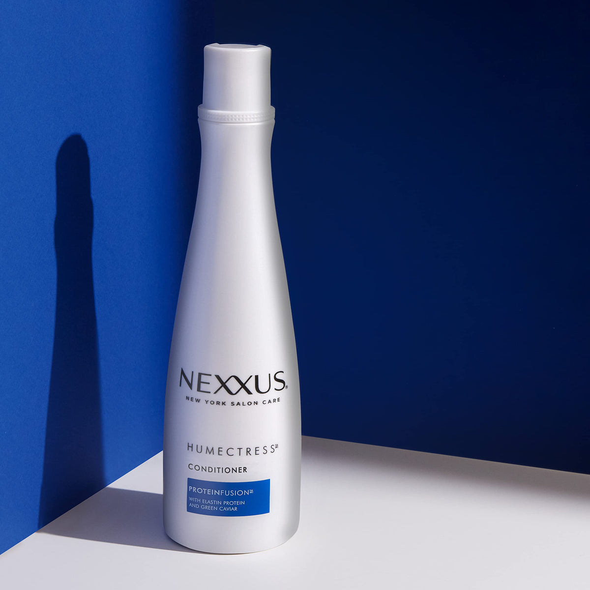 Applying Nexxus conditioner to wet hair for easier detangling benefit