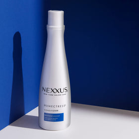Applying Nexxus conditioner to wet hair for easier detangling benefit