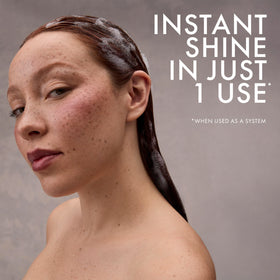 Nexxus being applied in shower demonstrating in-use protection