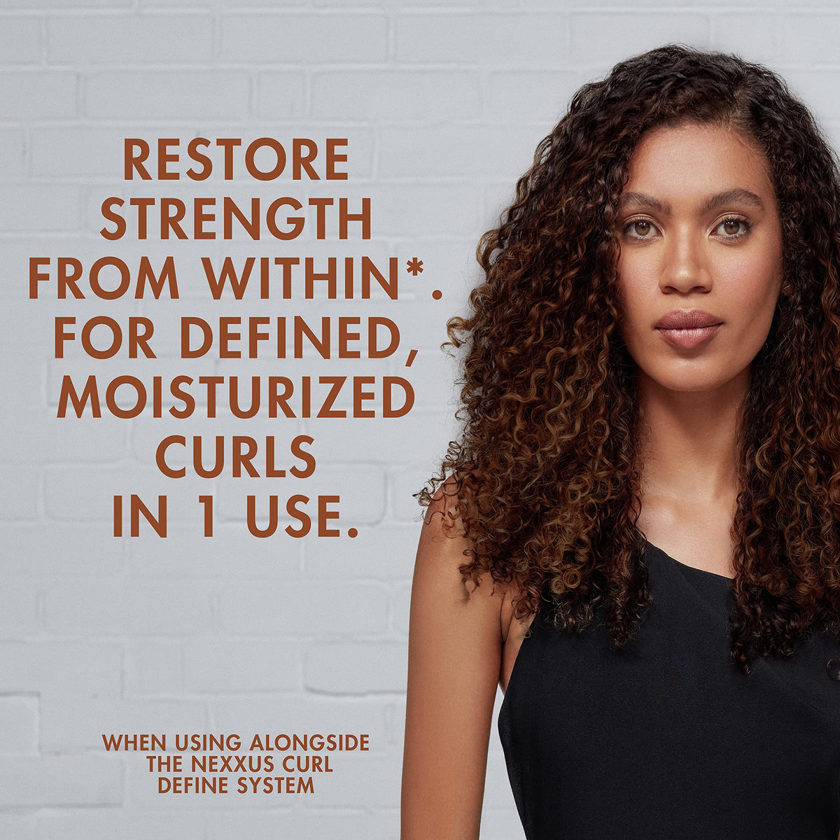 Model with defined curls after Nexxus showing hydrated smoother hair