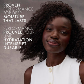Nexxus HUMECTRESS bottle on bath shelf conveying salon-quality routine