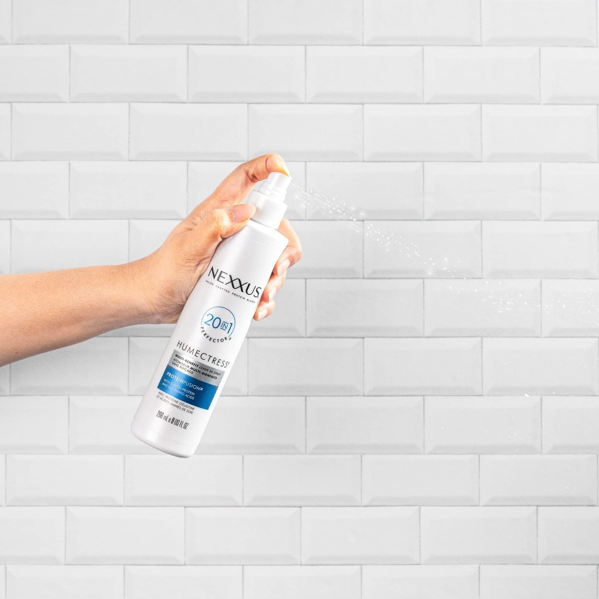 Nexxus spray applied to curly hair improving definition and frizz control