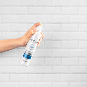 Nexxus spray applied to curly hair improving definition and frizz control