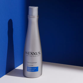 Nexxus 13.5 oz bottle in hand to show size and portable convenience