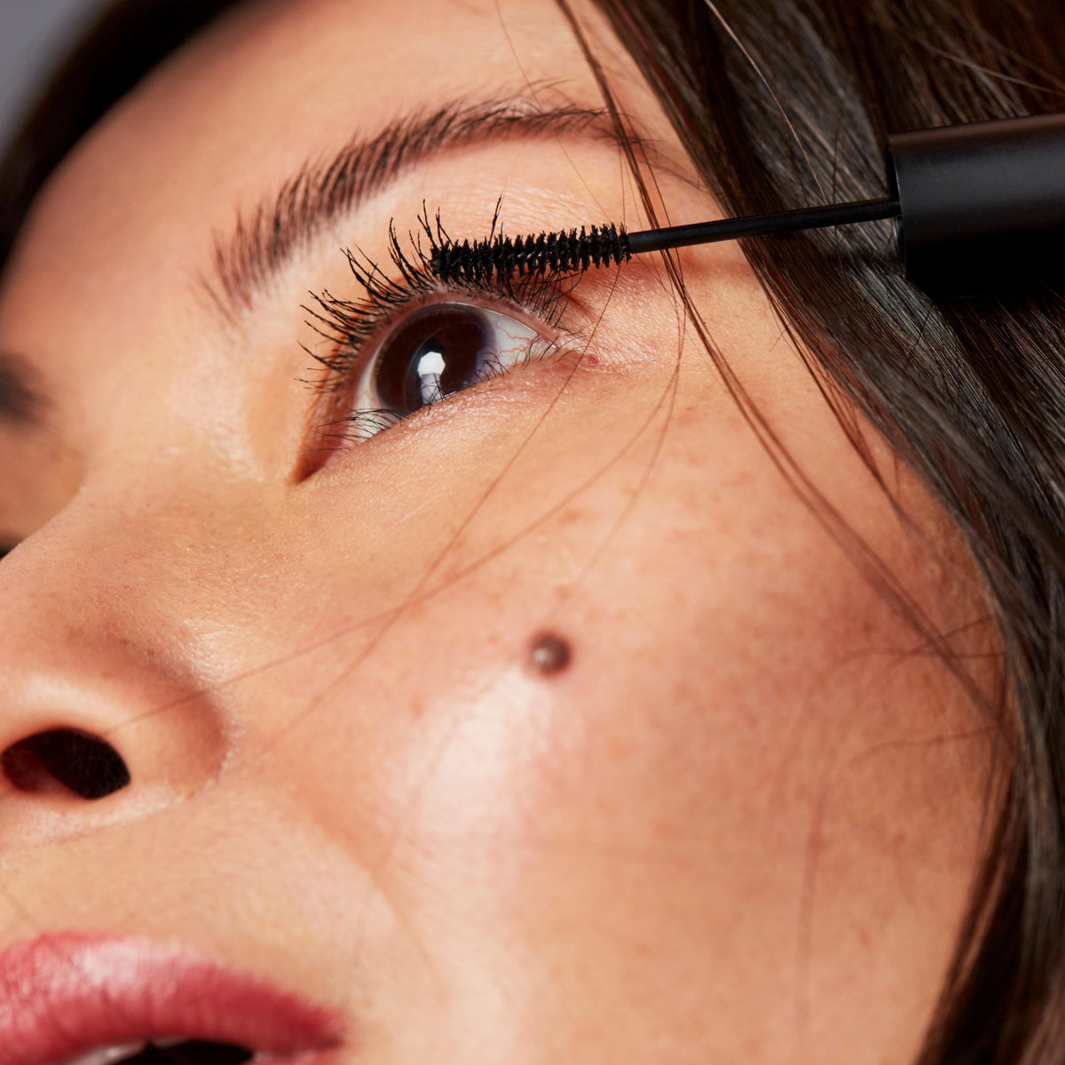 NINETEEN NINETY NINE lashes before and after showing defined darker lashes