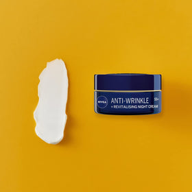 NIVEA jar on bedside table suggesting nightly restorative skincare routine