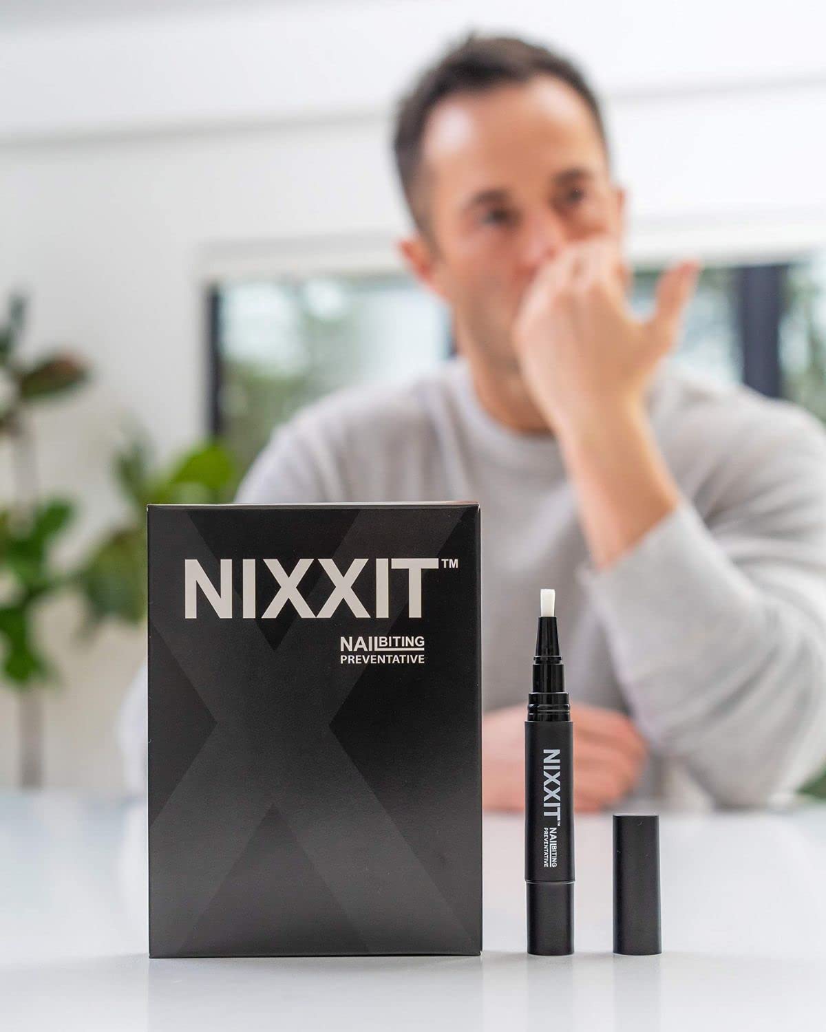 NIXXIT pen brush tip close-up demonstrating precise, mess-free application