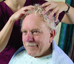 No-Rinse brand shown applied by caregiver in bed illustrating convenient waterless use