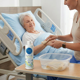 No-Rinse in-use sponge bath scene with caregiver using product, convenient hygiene benefit