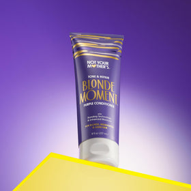 Not Your Mother's purple shampoo being applied to wet hair for toning