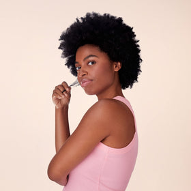Not Your Mother's curl set on bathroom shelf with flowers for aromatic spa-like benefit
