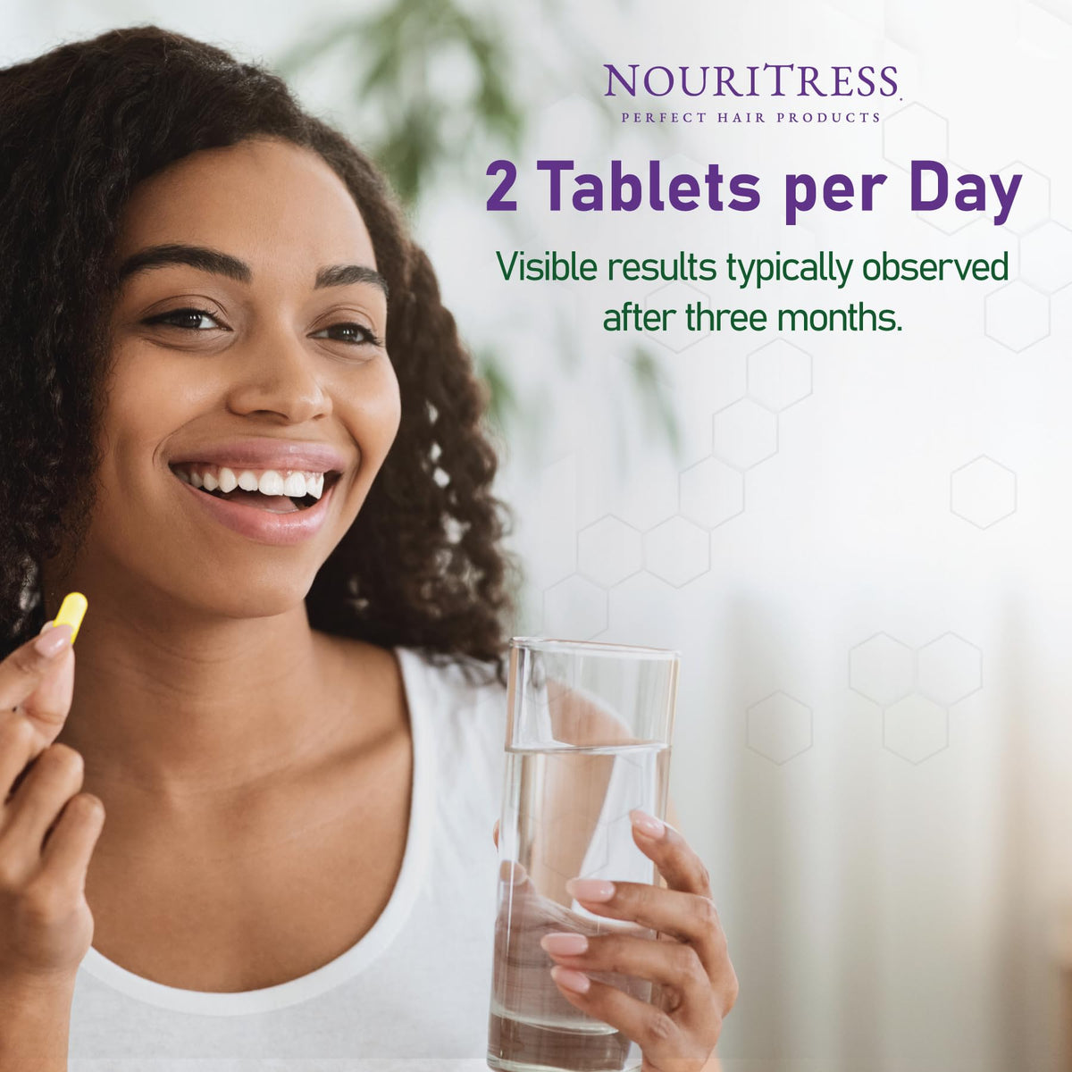 Scattered NouriTress tablets flatlay with botanicals, illustrates natural-ingredient focus benefit