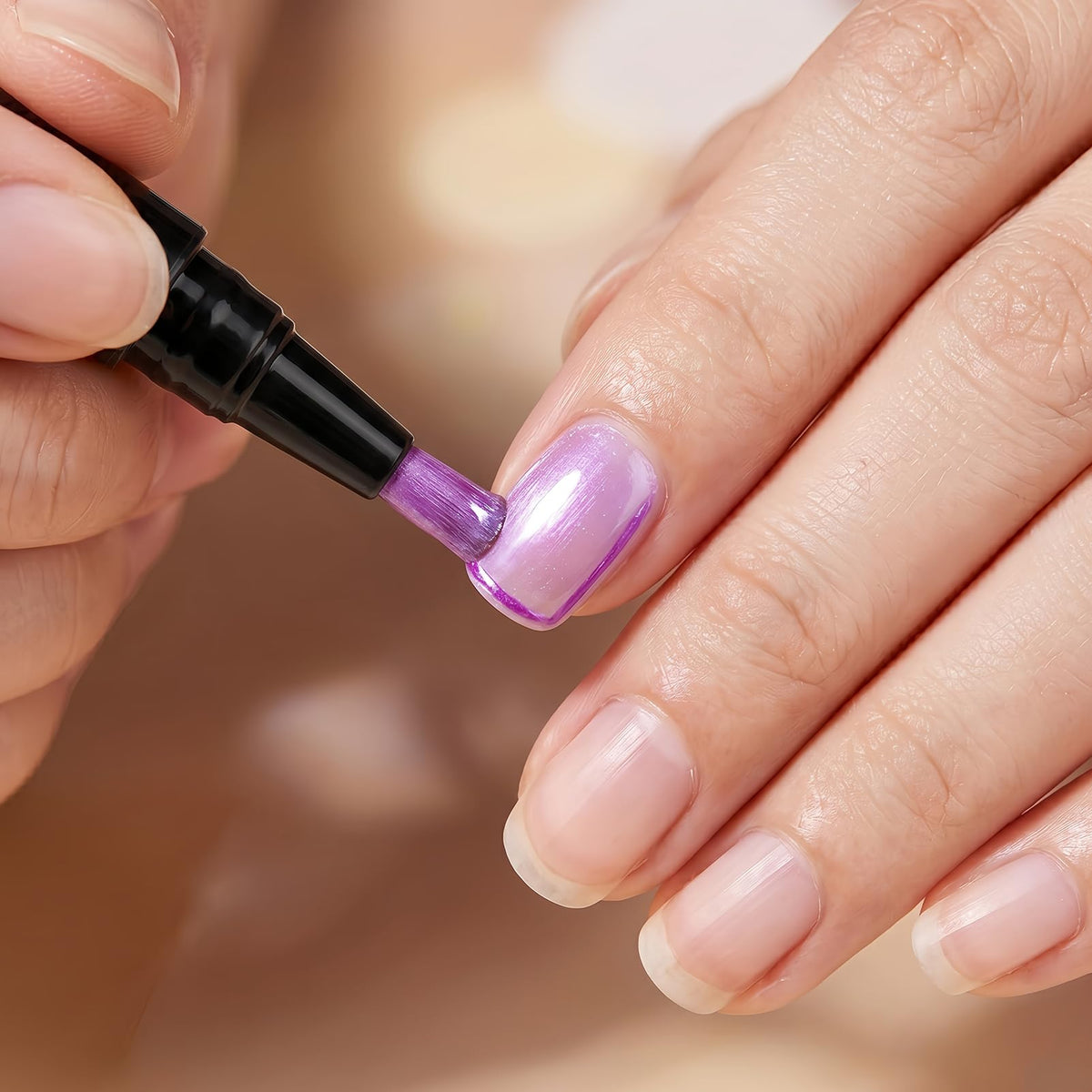 NovaCharm pen in use painting a fingernail demonstrating quick air-dry convenience