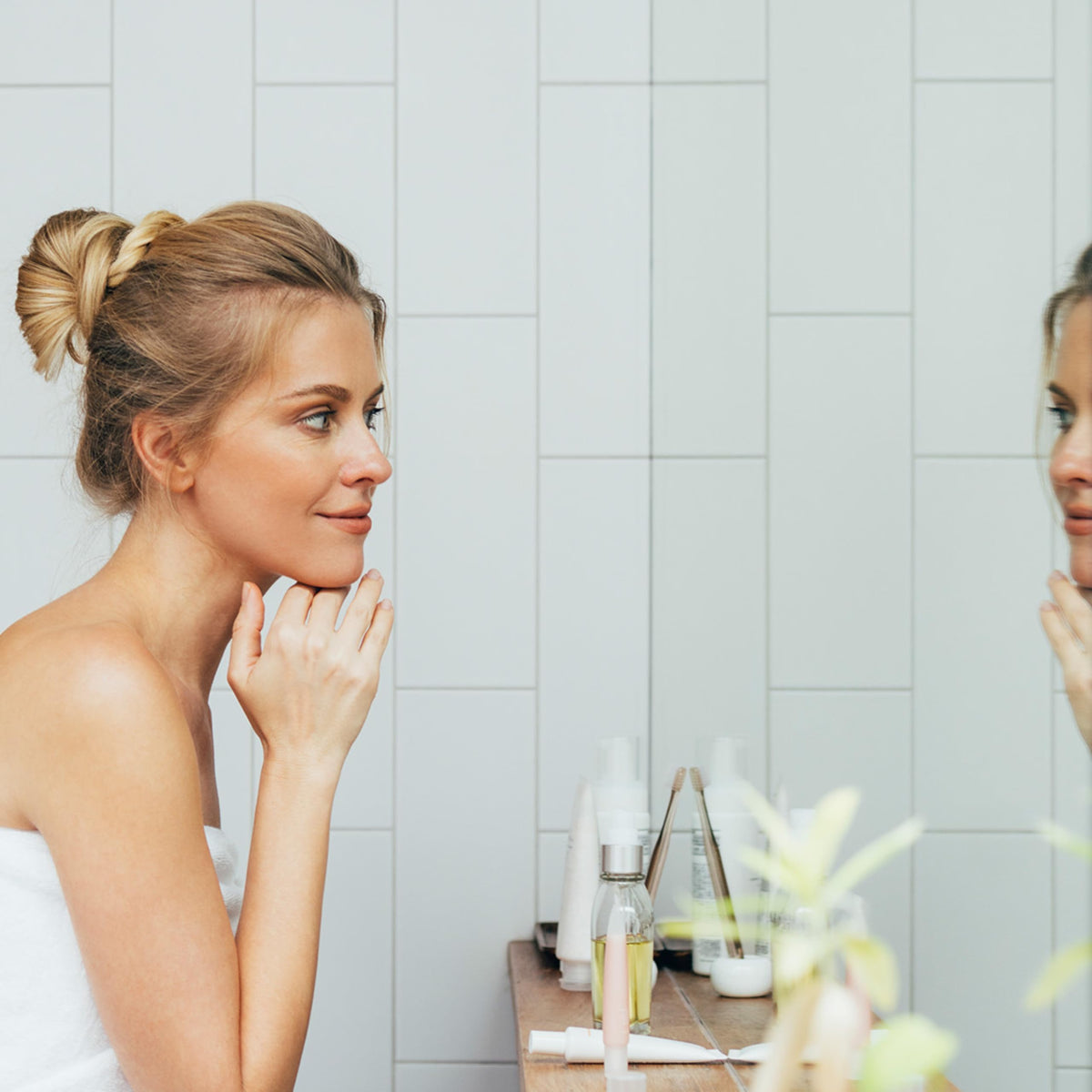 Nu Skin jar on bathroom counter in routine setting, implies daily use benefit