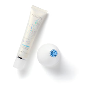 Nu Skin IdealEyes next to coin for scale showing compact size that's travel friendly