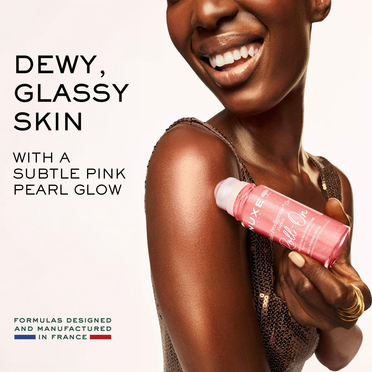 NUXE shimmering oil texture pooled to show pink‑gold iridescence and nourishing finish