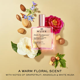 NUXE bottle with botanical oils flatlay emphasizing nourishing ingredients benefit