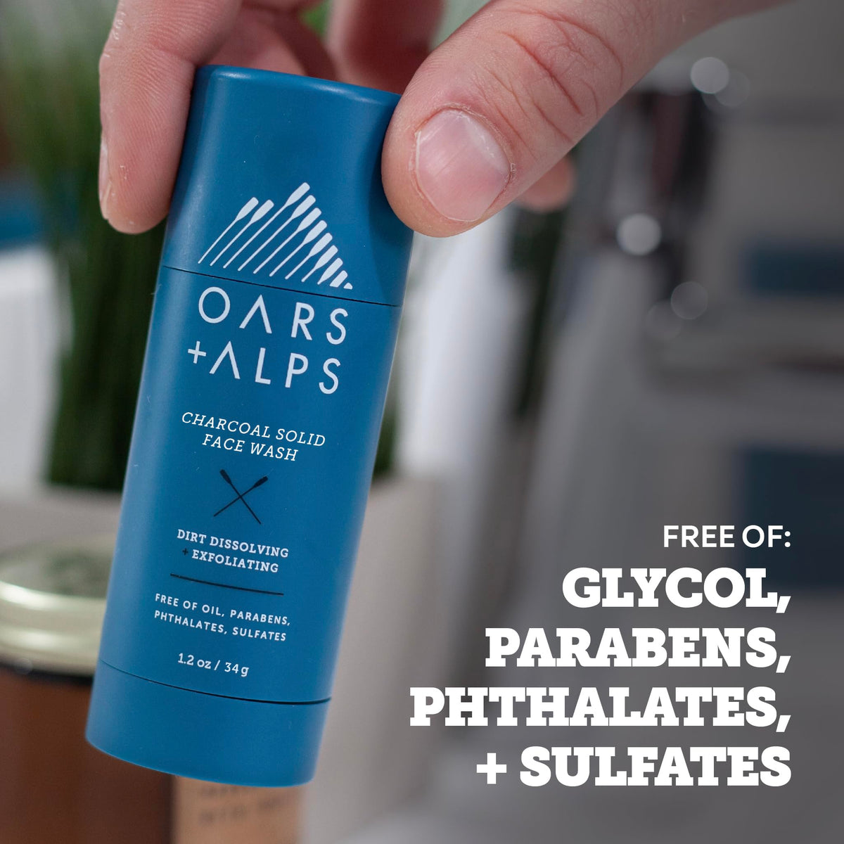 Oars + Alps applying stick to wet face illustrating quick cleanse and exfoliation