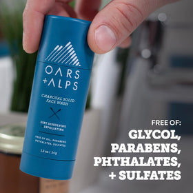 Oars + Alps applying stick to wet face illustrating quick cleanse and exfoliation