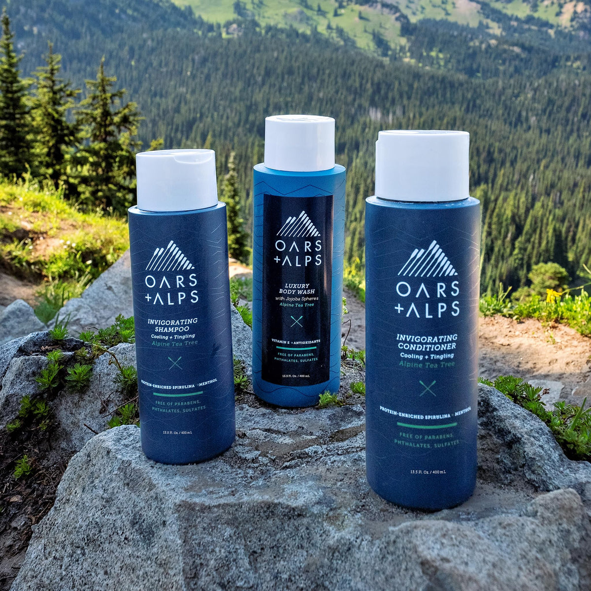 Oars + Alps bottle in hand to show size and travel-friendly 13.5oz benefit