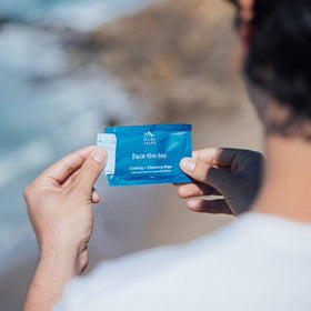 Oars + Alps wipes on travel table showing TSA-friendly convenience and freshening benefit