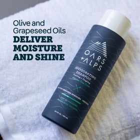 Oars + Alps shampoo on shower shelf in morning routine for energized start