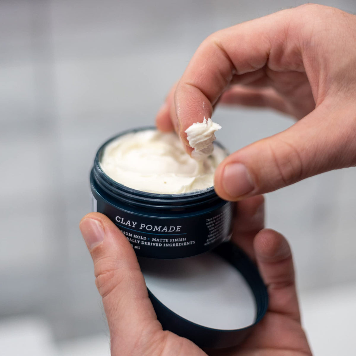 Oars + Alps open jar with clay exposing pliable consistency