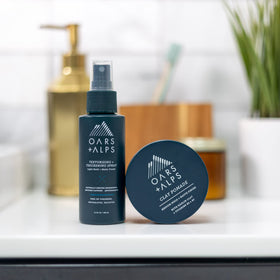 Oars + Alps pomade beside a coin for 2 oz size comparison