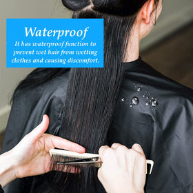 OBTANIM cape draped on client in salon demonstrating protection during haircut