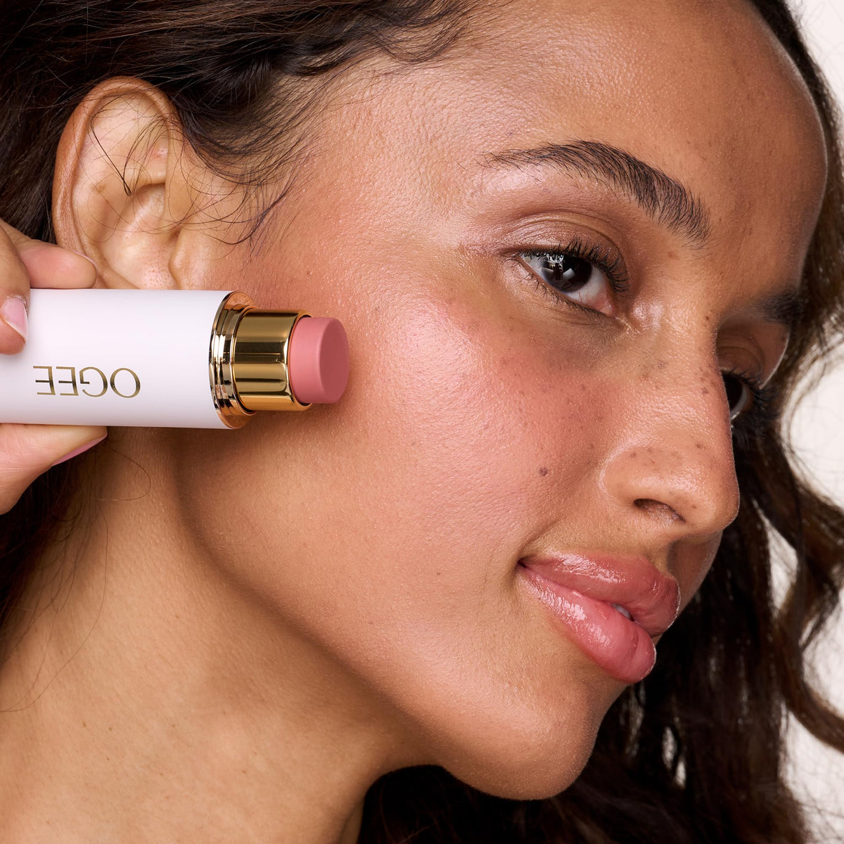 Ogee face stick blended on model cheek for natural radiance