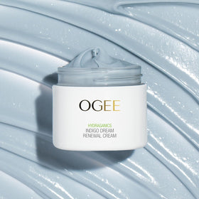 Ogee cream beside flowers illustrating botanical formulation and soothing benefit