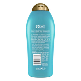 OGX 25.4 fl oz bottle next to hand showing product size and value