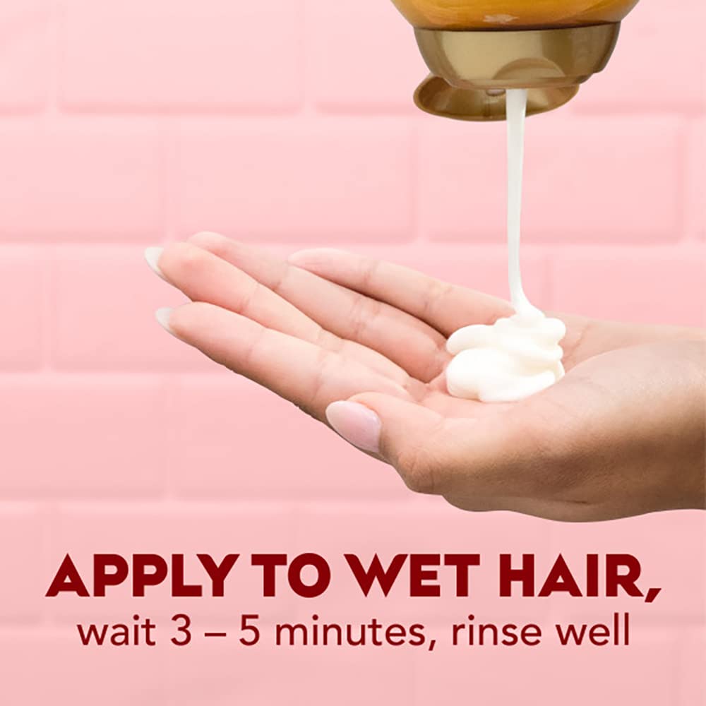 OGX conditioner pouring into hand to show consistency and easy application benefit