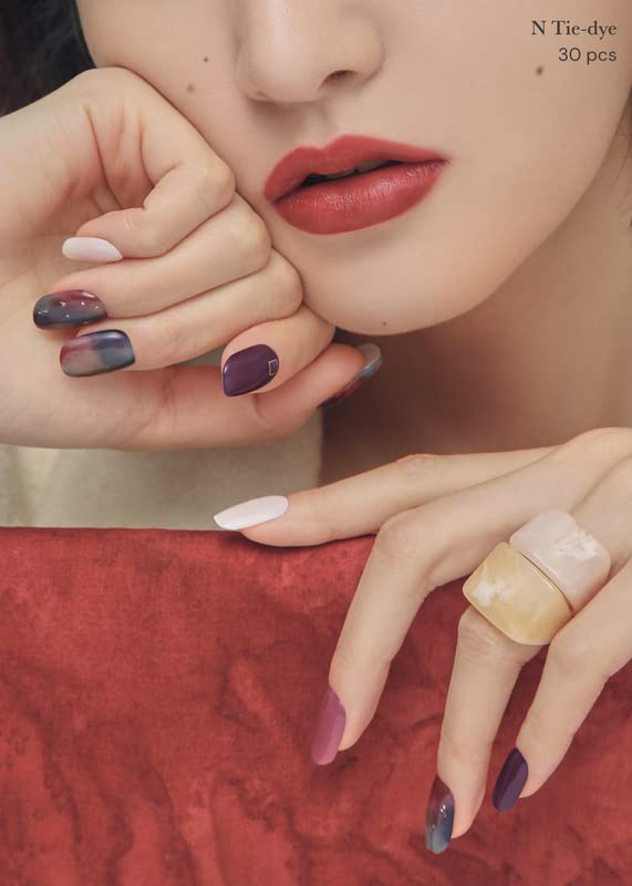 ohora manicured hands wearing purple ombre strips showing polished result benefit