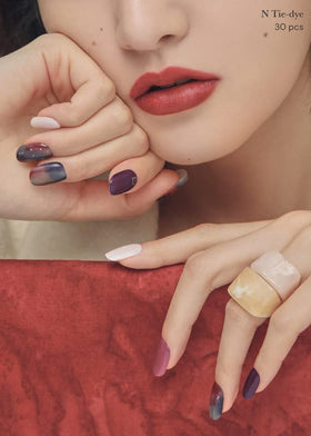 ohora manicured hands wearing purple ombre strips showing polished result benefit