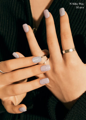 ohora hand applying a strip demonstrating simple at-home manicure control and speed