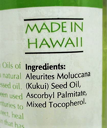 Oils of Aloha bottle in hand showing 4 fl oz size for travel convenience